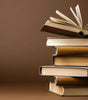 Stack of books with one book open on top.